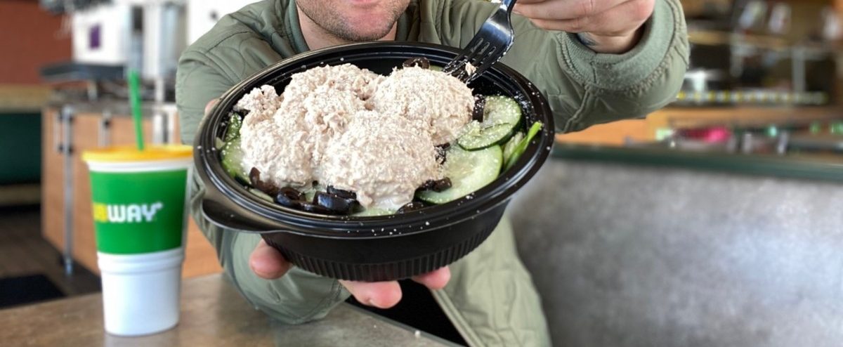 man holding tuna protein bowl