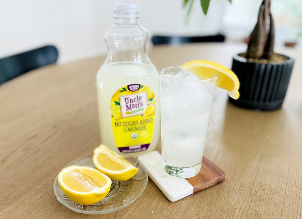 uncle matt lemonade with fresh lemon in glass sitting on wood table