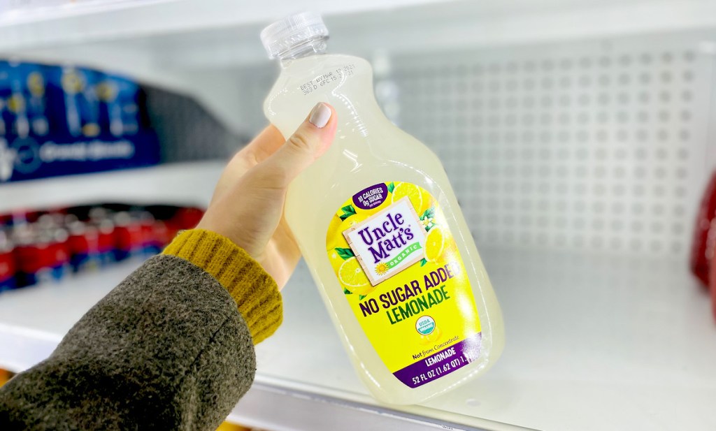 hand holding a large bottle of uncle matts sugar free keto lemonade