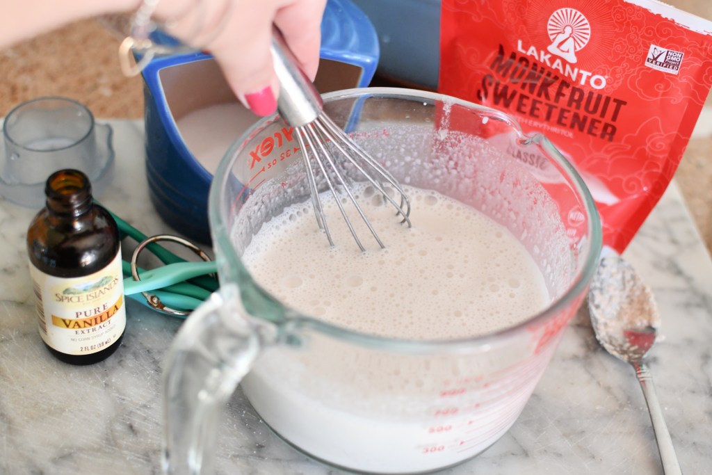 whisking keto almond milk with monk fruit, salt, and vanilla