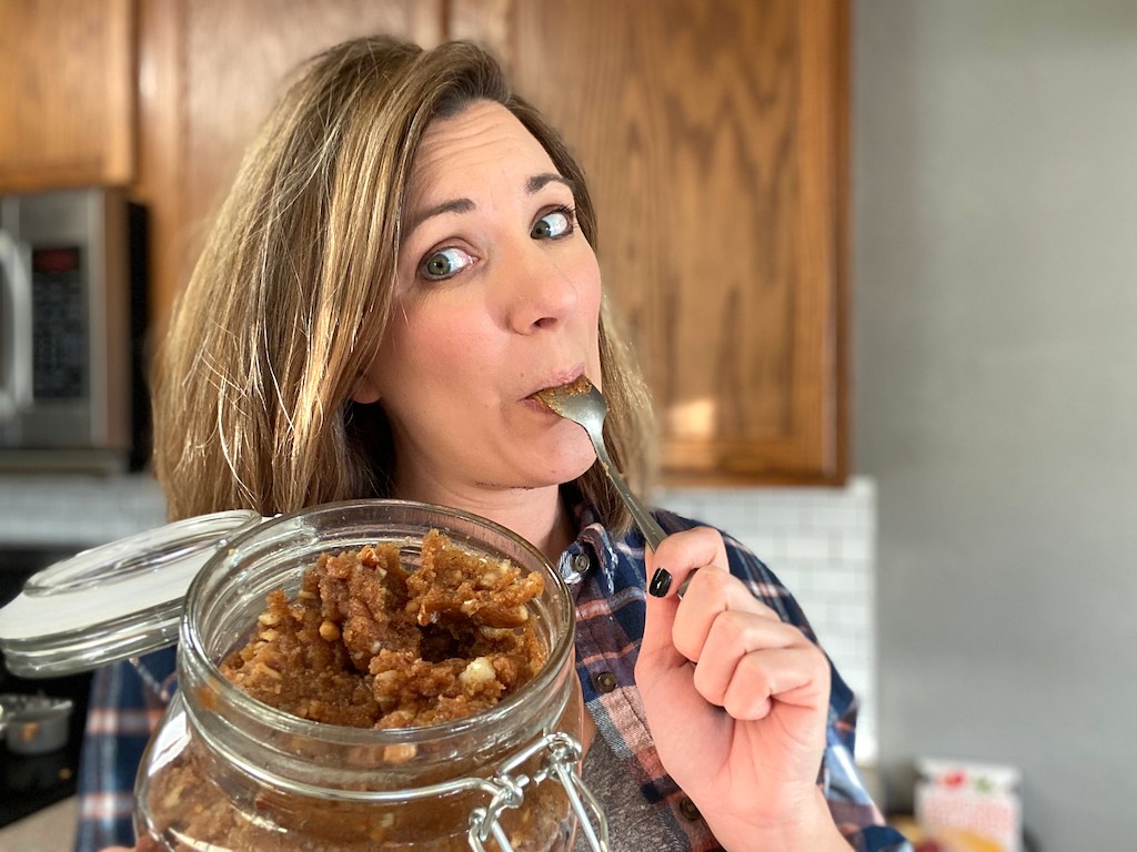 woman enjoying a spoonful of edible keto cookie dough 