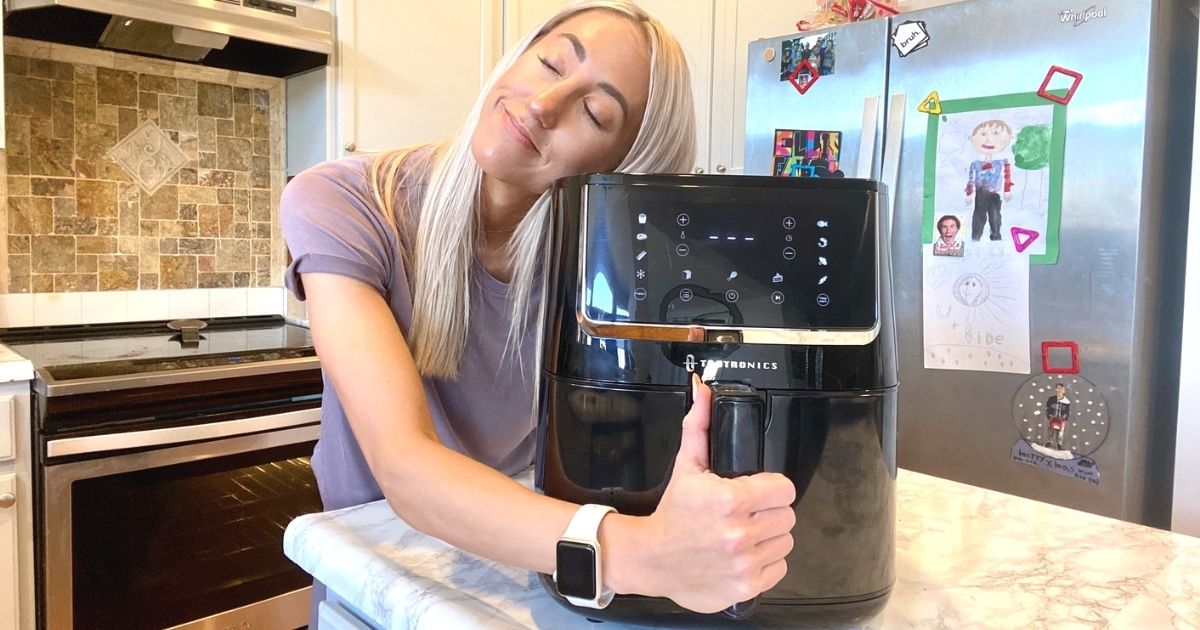 A woman hugging her air fryer