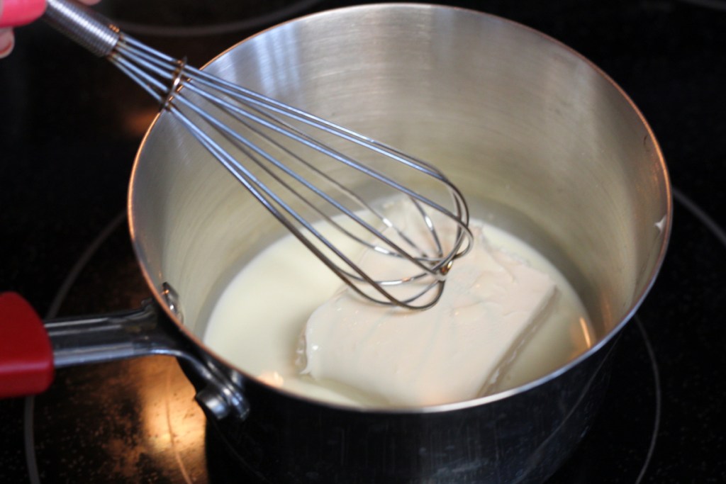 cream cheese and heavy cream in a saucepan melting