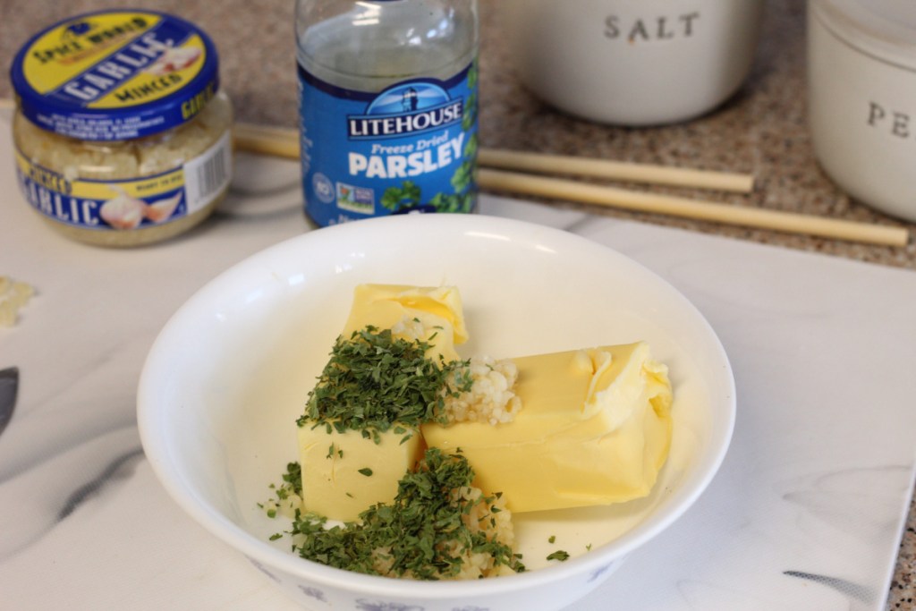 bowl of butter, garlic, and parsley