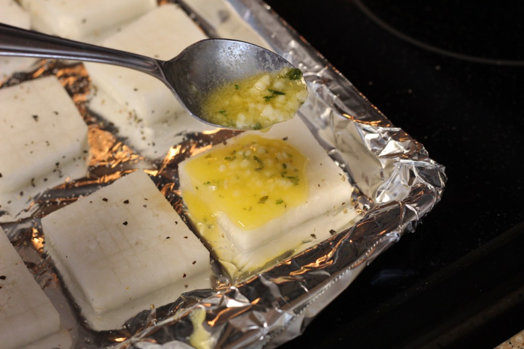 drizzling melted garlic butter over daikon radishes