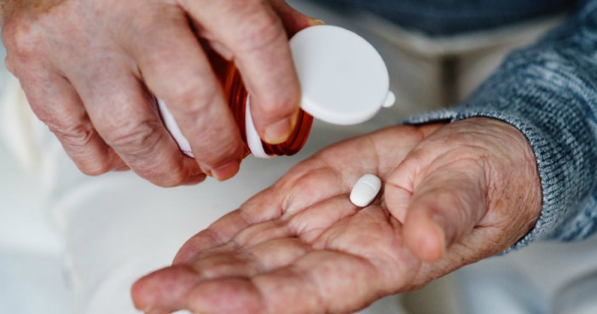 pill from bottle in hand