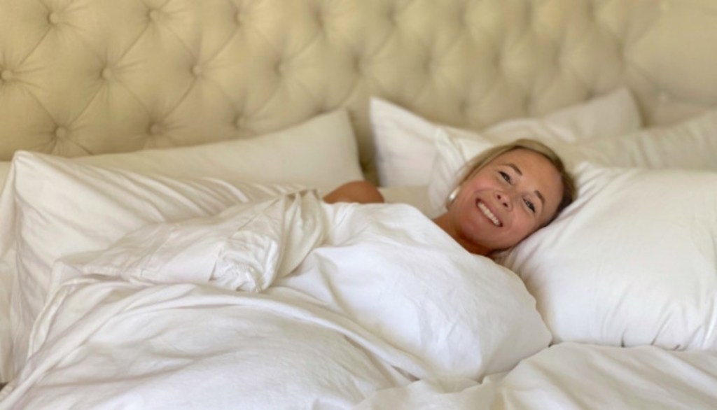 woman in bed with white sheets