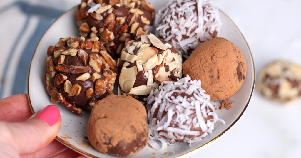 plate of keto chocolate truffles with nuts and coconut 