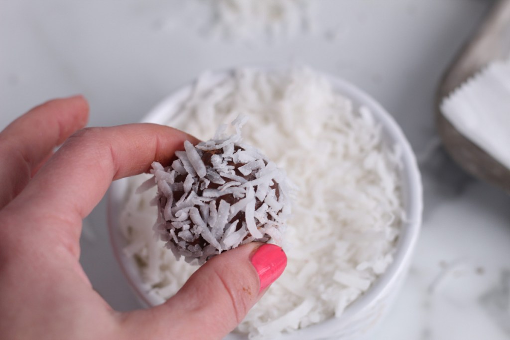 adding shredded coconut to the keto chocolate truffle