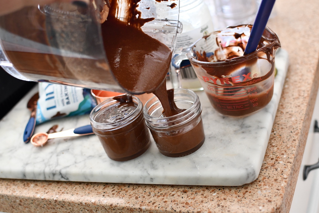 pouring keto hazelnut spread in jar 