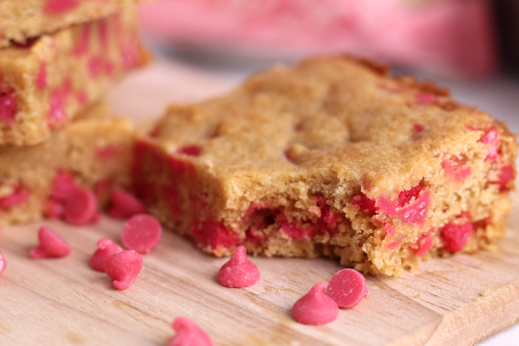 keto strawberry blondie with a bite taken from it 