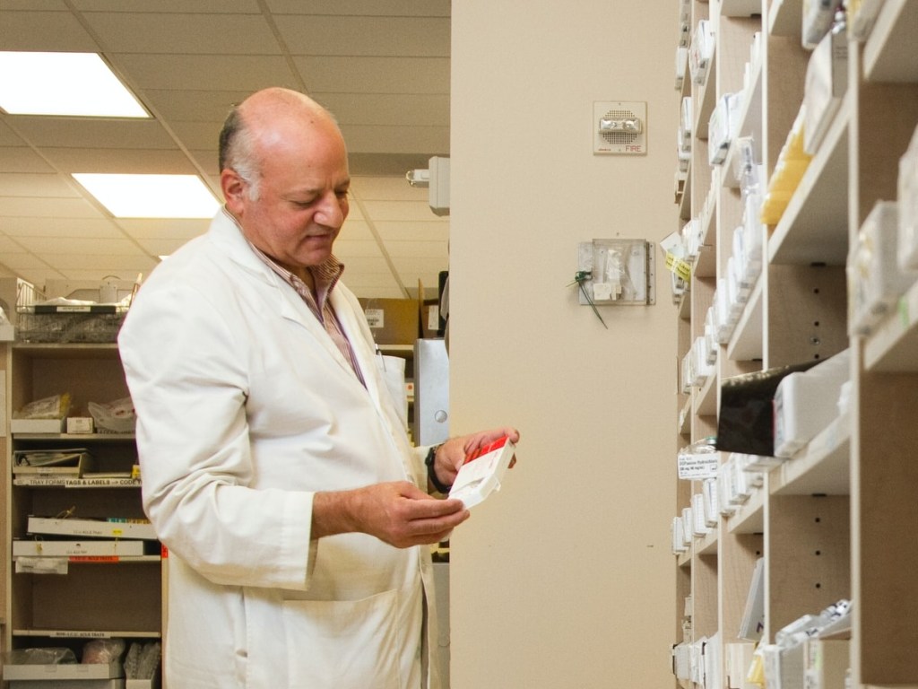 pharmacist holding medication to lower cortisol levels