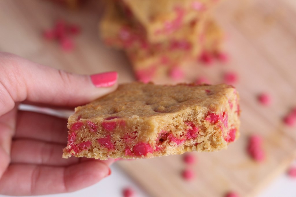 girl holding strawberry keto blondies