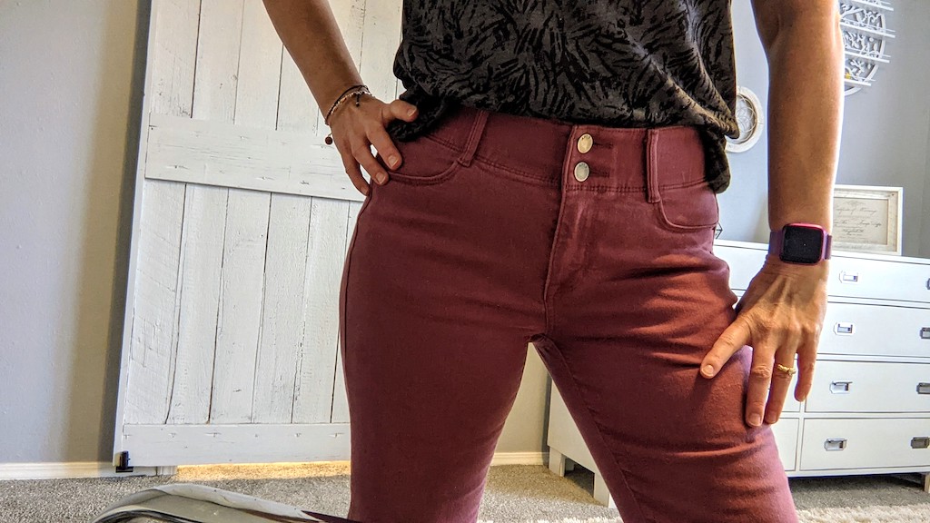 woman wearing jeans showing off slim waist 