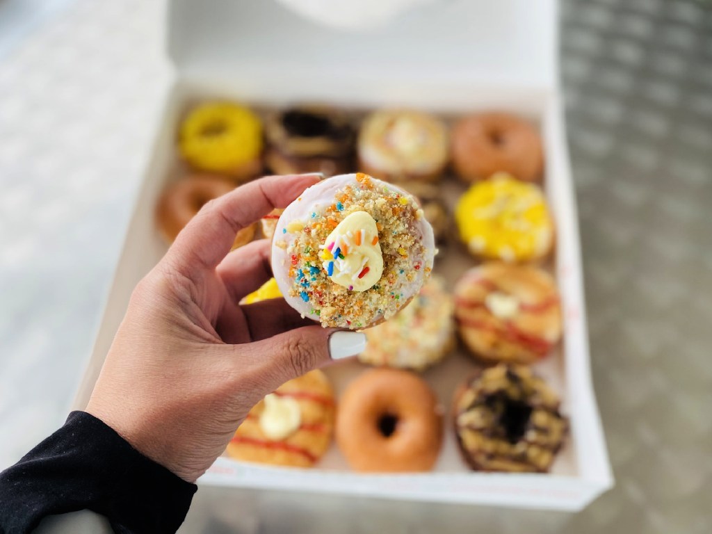 holding a mini-doughnut