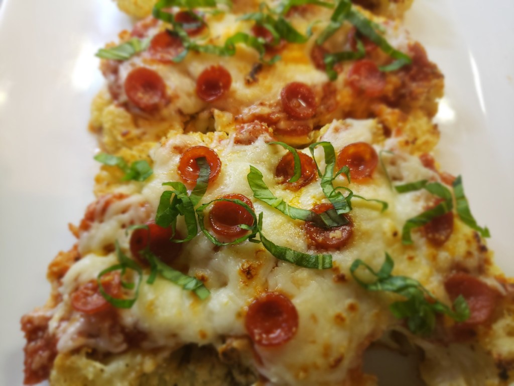 slices of keto cauliflower parm a tray