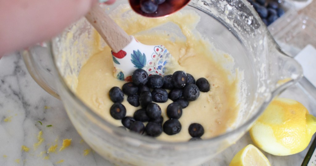 adding blueberries to pound cake