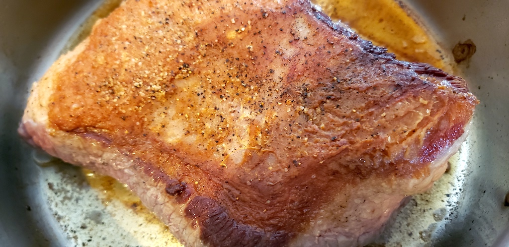 seasoned keto brisket in pan 