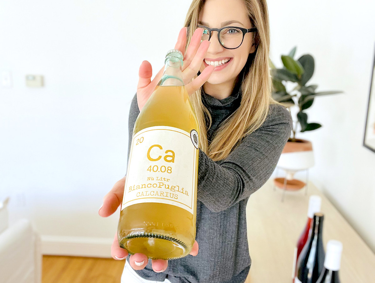 woman holding bottle of dry farm wine