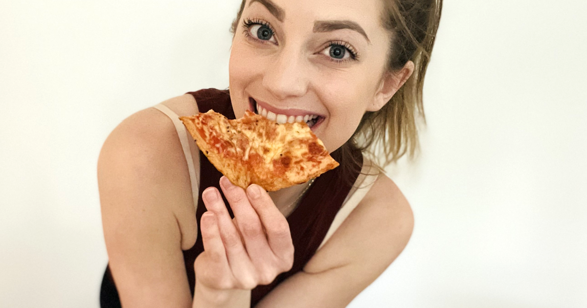 woman eating keto pizza slice 