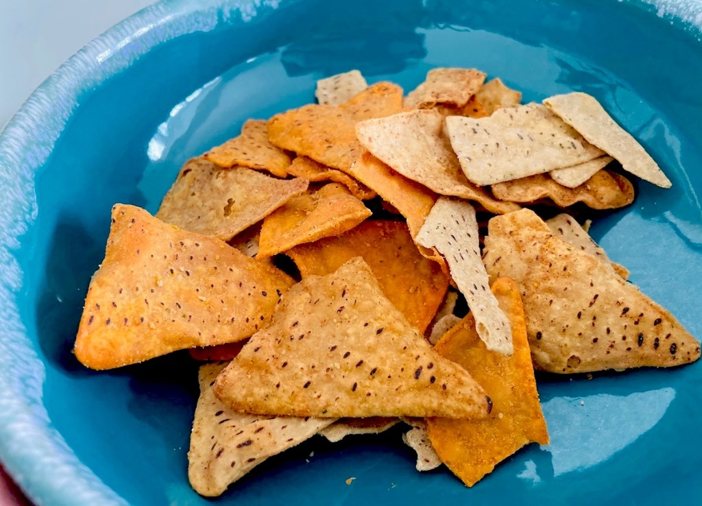 close up of blue bowl full of chips