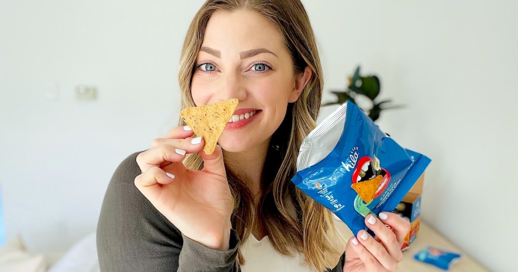 woman holding bag of hilo chips showing close up of chip