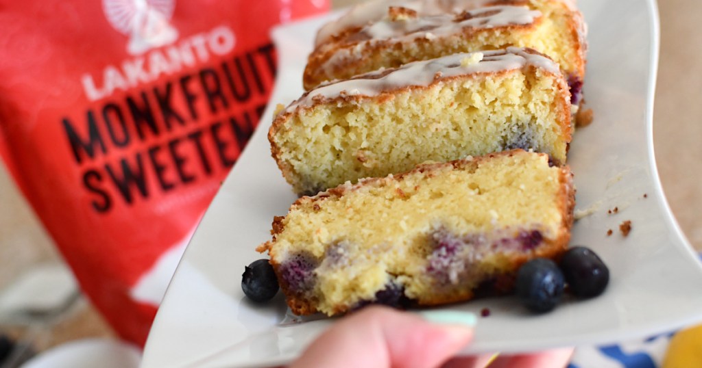 holding plate with sliced keto blueberry pound cake 
