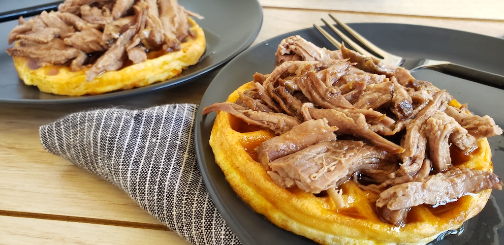 keto brisket chaffles on plates with maple hot sauce 