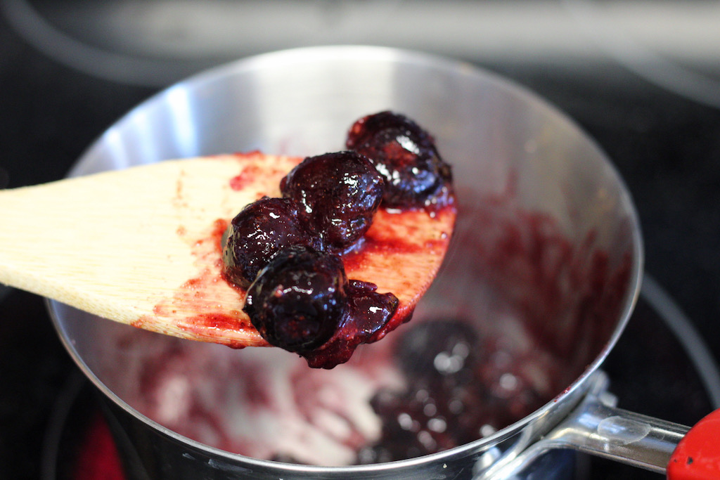 wooden spoon with mashed up cherries 