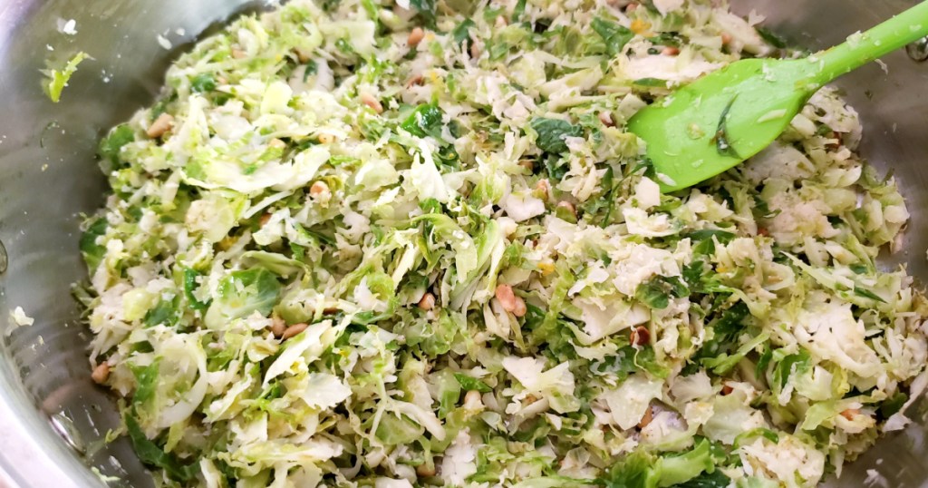 mixing brussels sprouts salad in bowl 