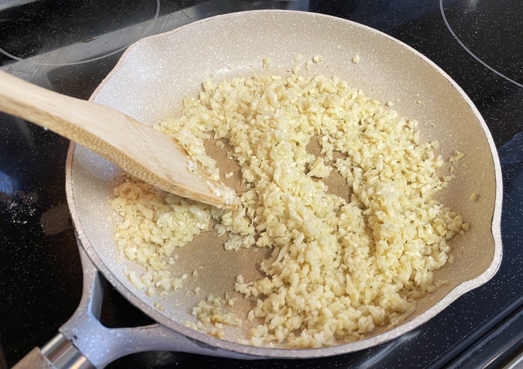 cooking palmini rice in a pan