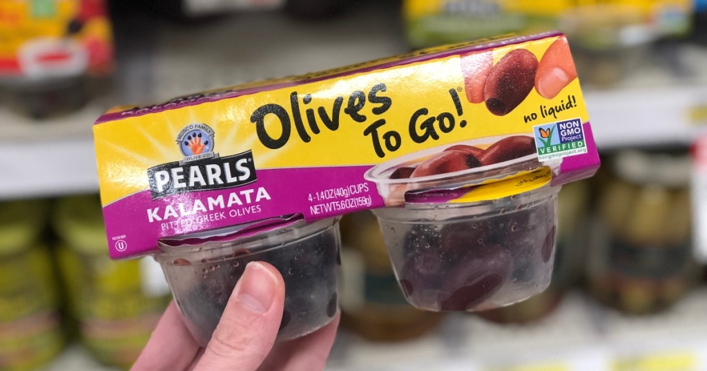 holding a 4-pack of single-serve olives