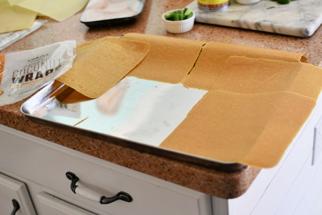 placing coconut wraps on sheet pan