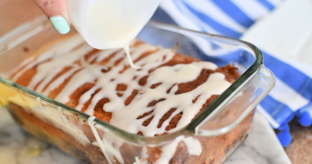 pouring lemon glaze over pound cake