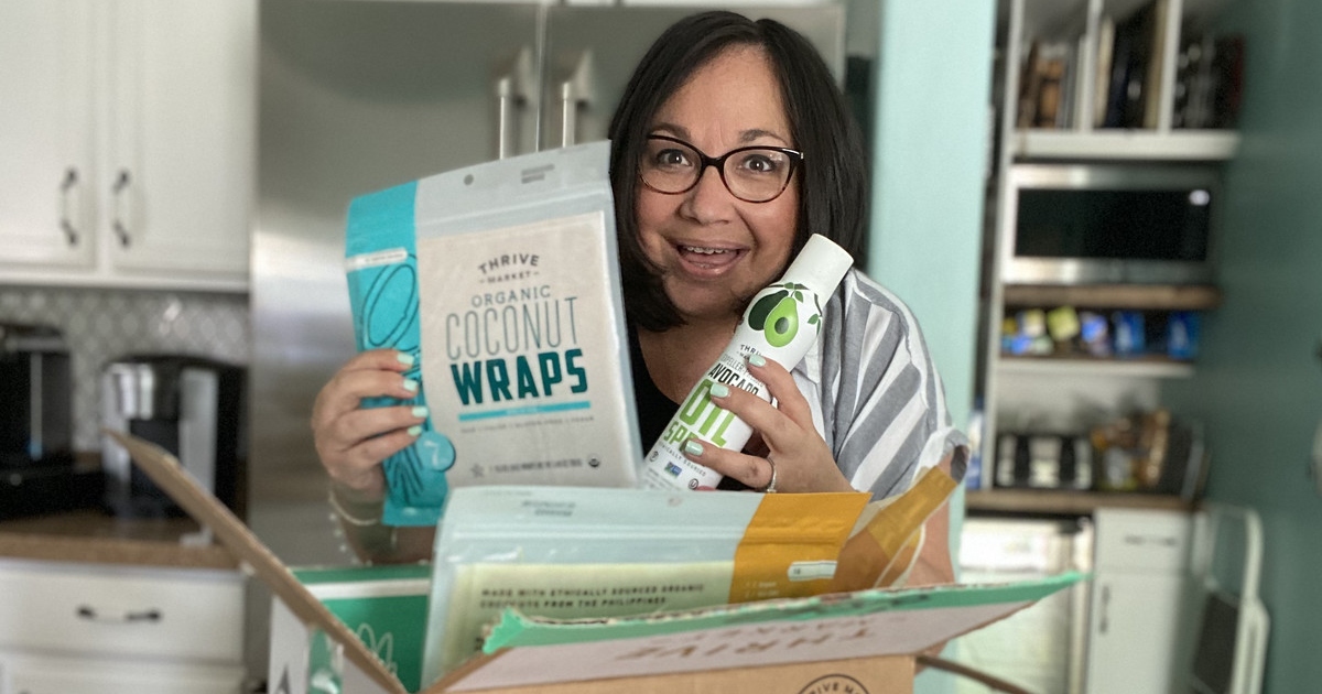 woman pulling keto items out of Thrive Market box