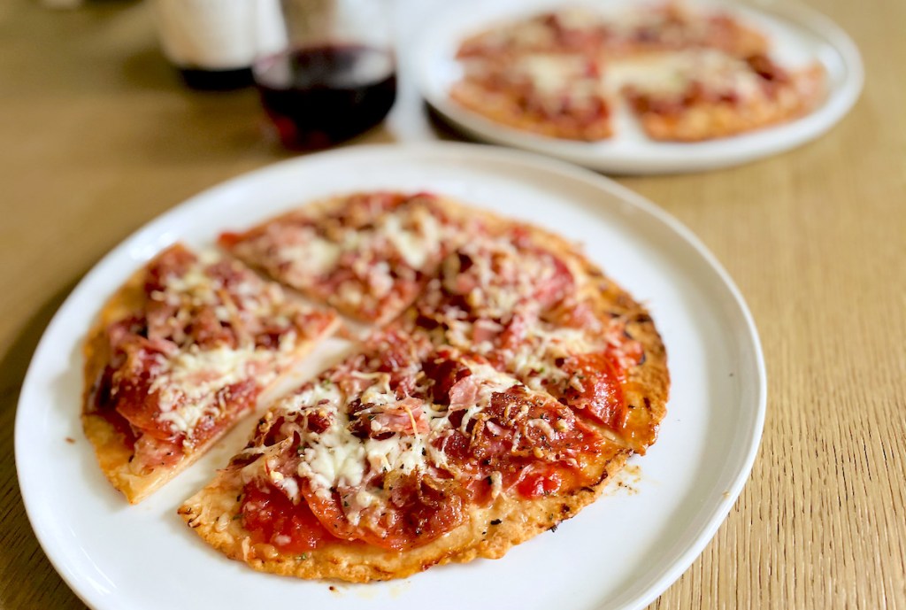 two keto meat lovers pizzas with keto wine in background