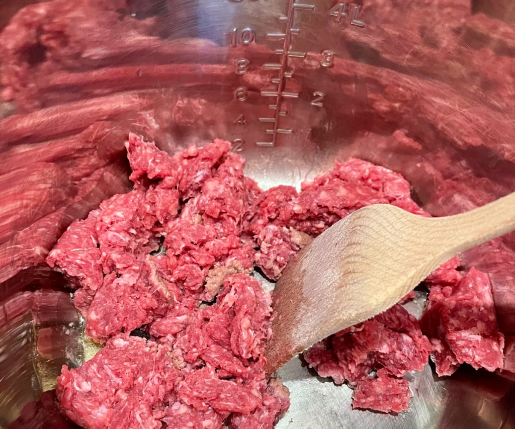 ground beef in instant pot with wood spoon