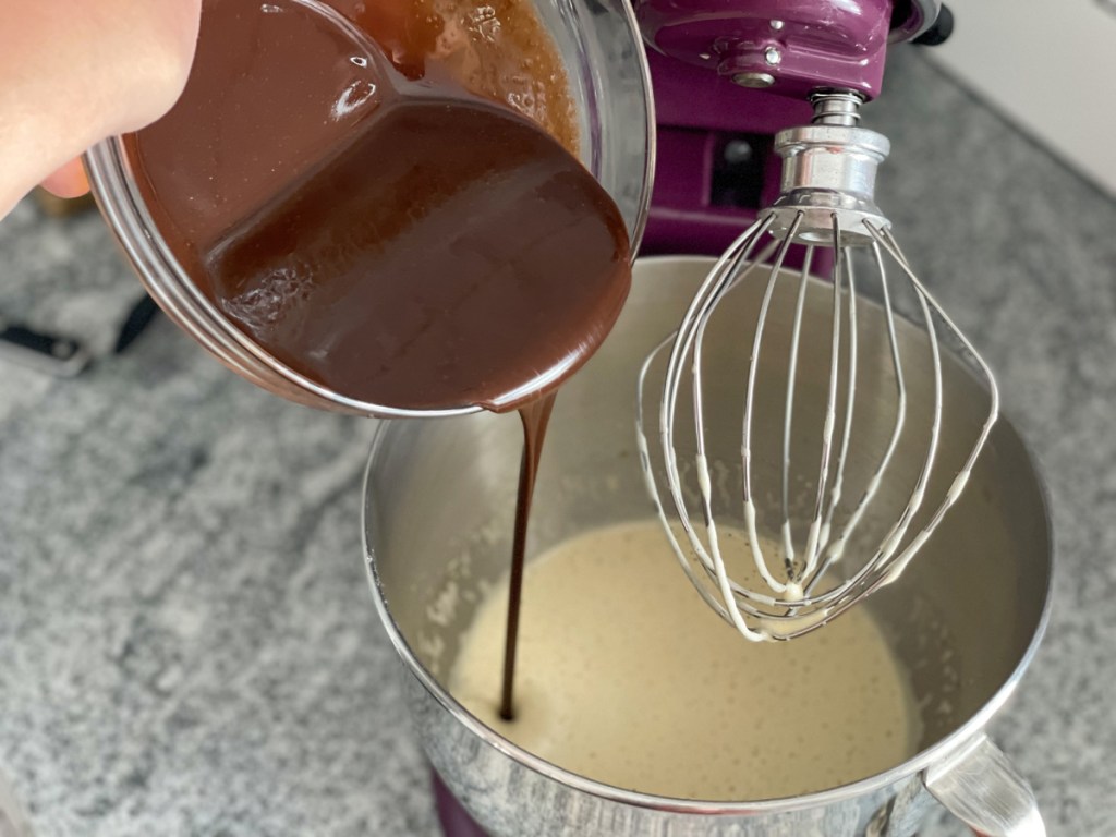 adding melted chocolate to mixing bowl