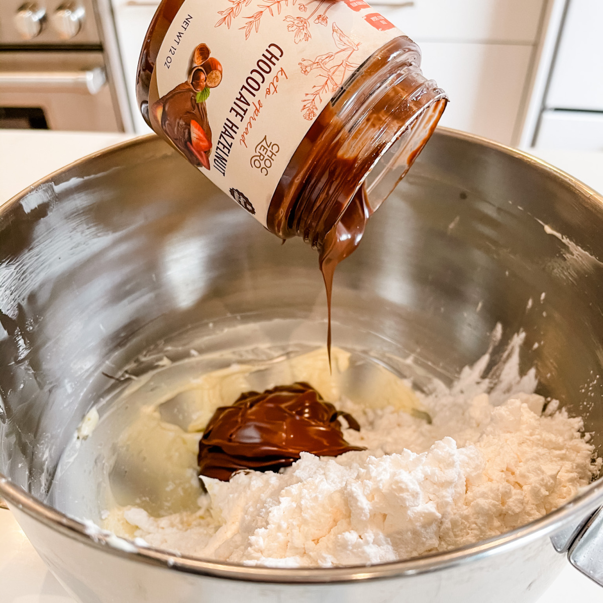 ChocZero chocolate hazelnut spread dripping into bowl 