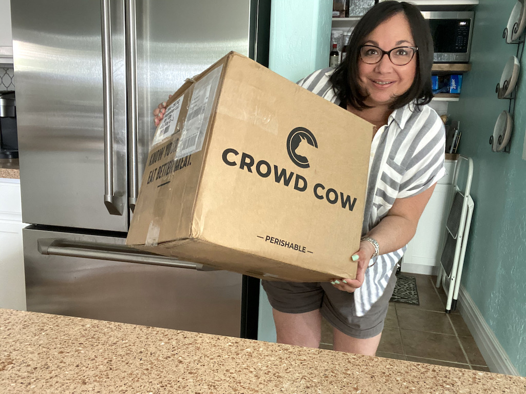 woman holding Crowd Cow box 