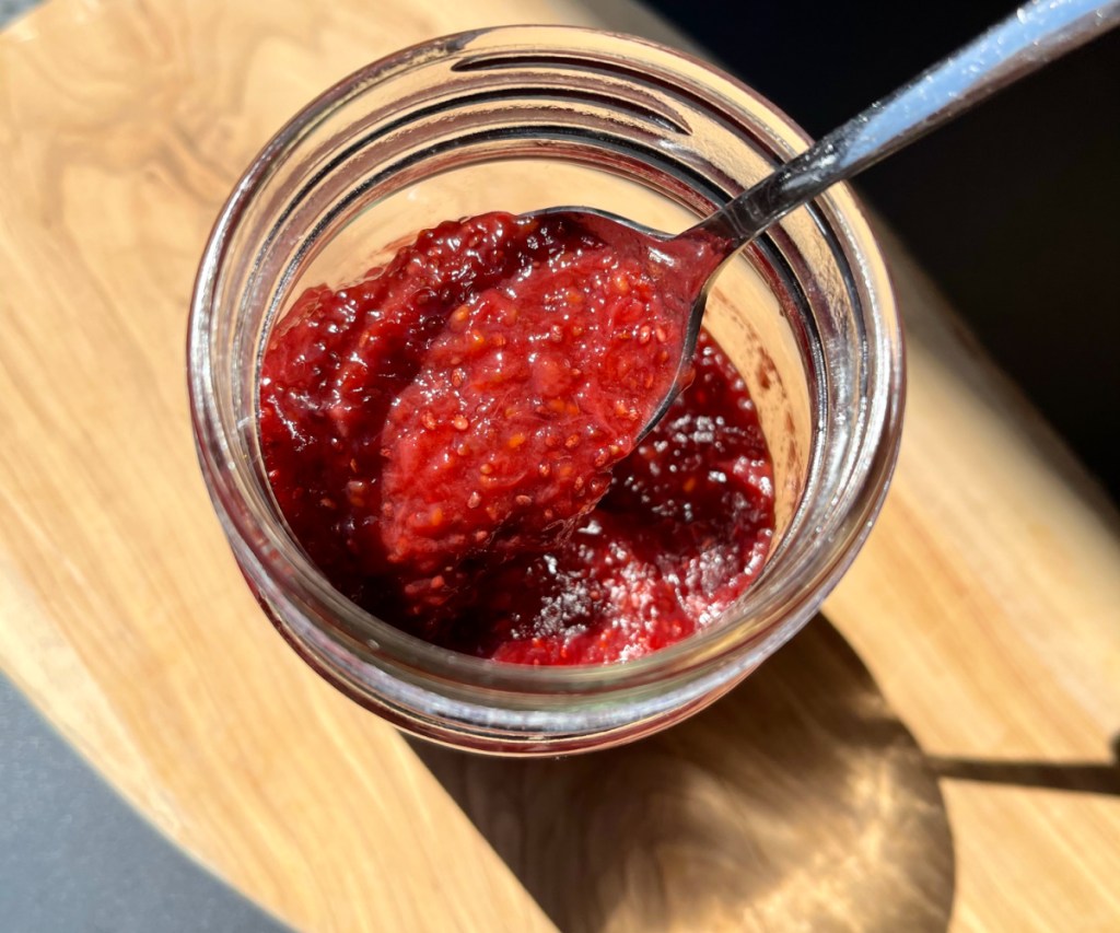 berry jam in jar with spoon 