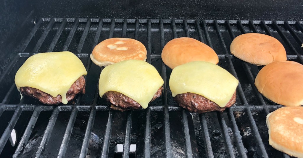 burgers and buns on a grill