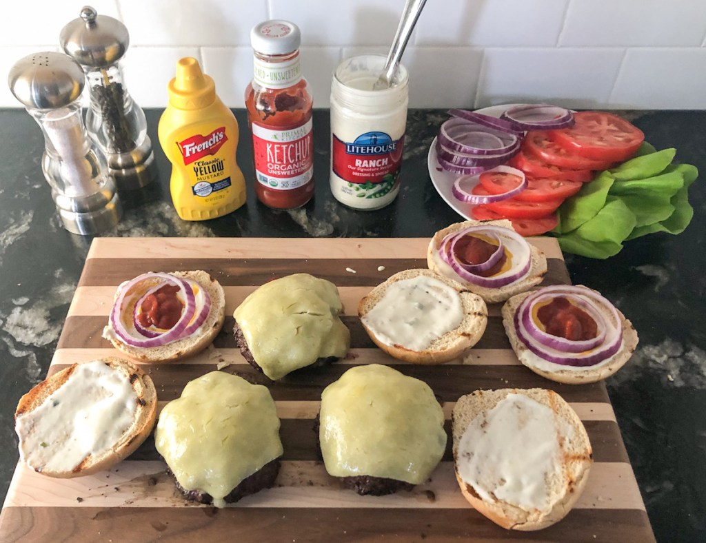 cooked burgers with toppings