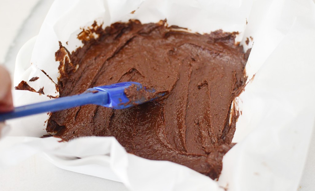 spreading keto brownie batter in pan