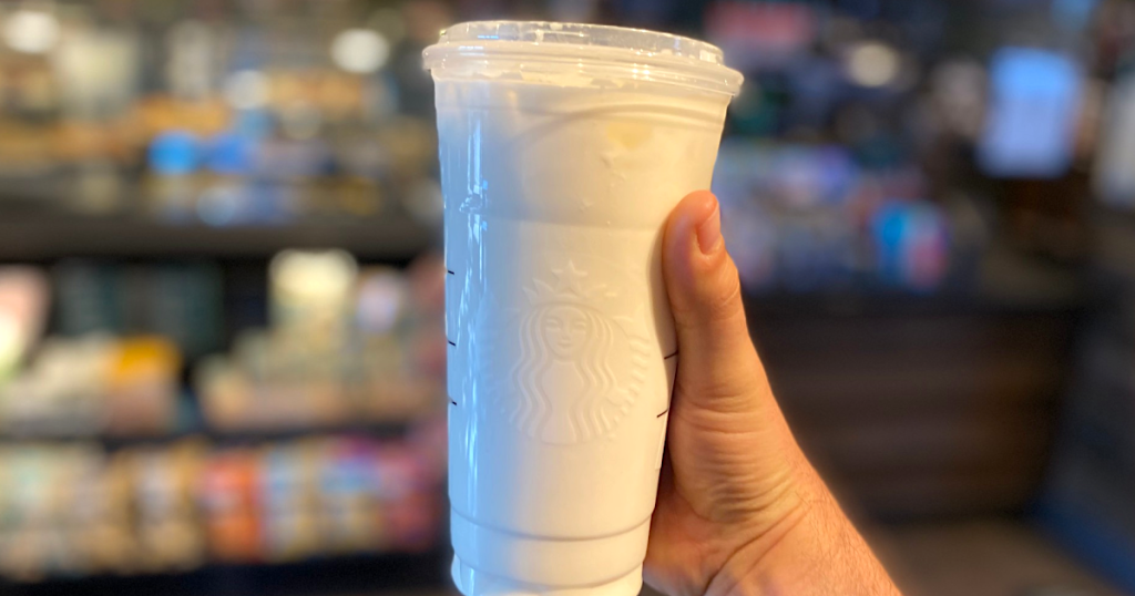 holding Starbucks keto peaches and cream drink