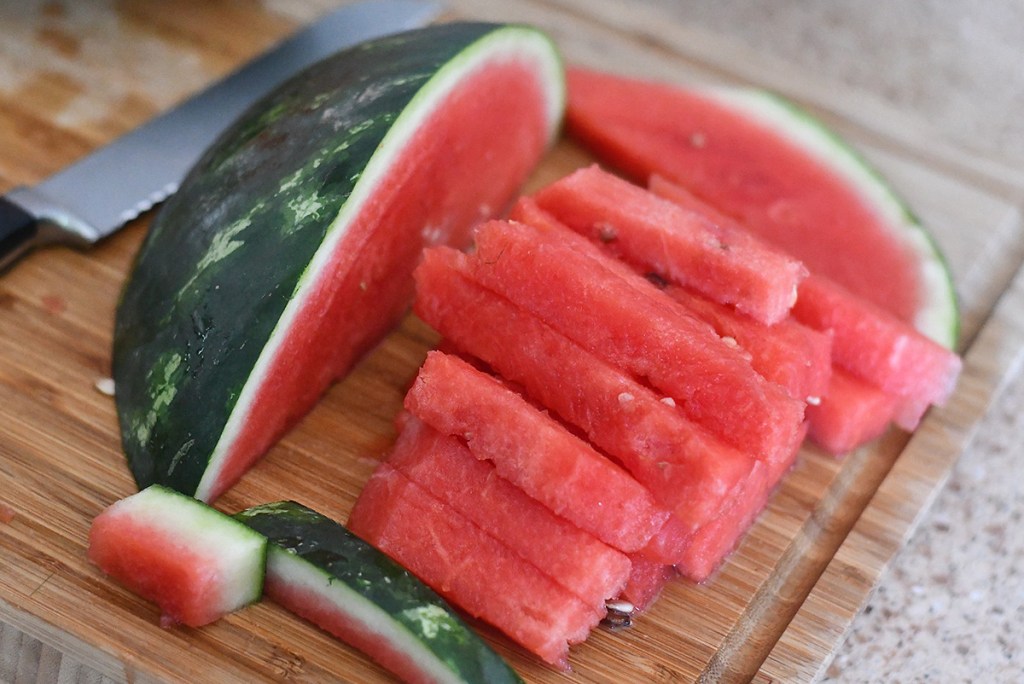 sliced watermelon on wood cutting board - clean 15