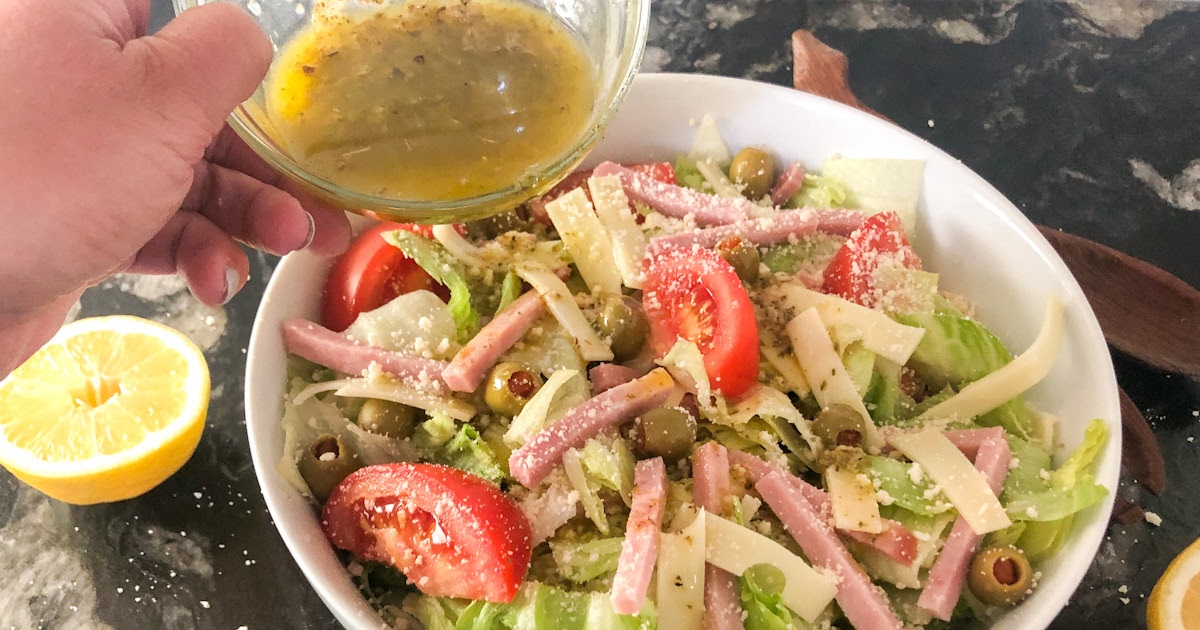 pouring dressing on a low carb salad 