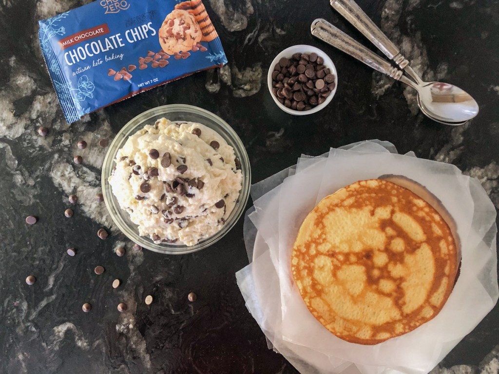 chocolate chips, sugar-free cannoli filling, and keto crepes on a counter