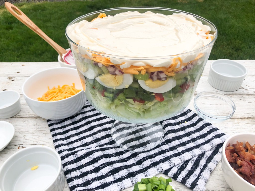 mayonnaise spread out on top of layered salad