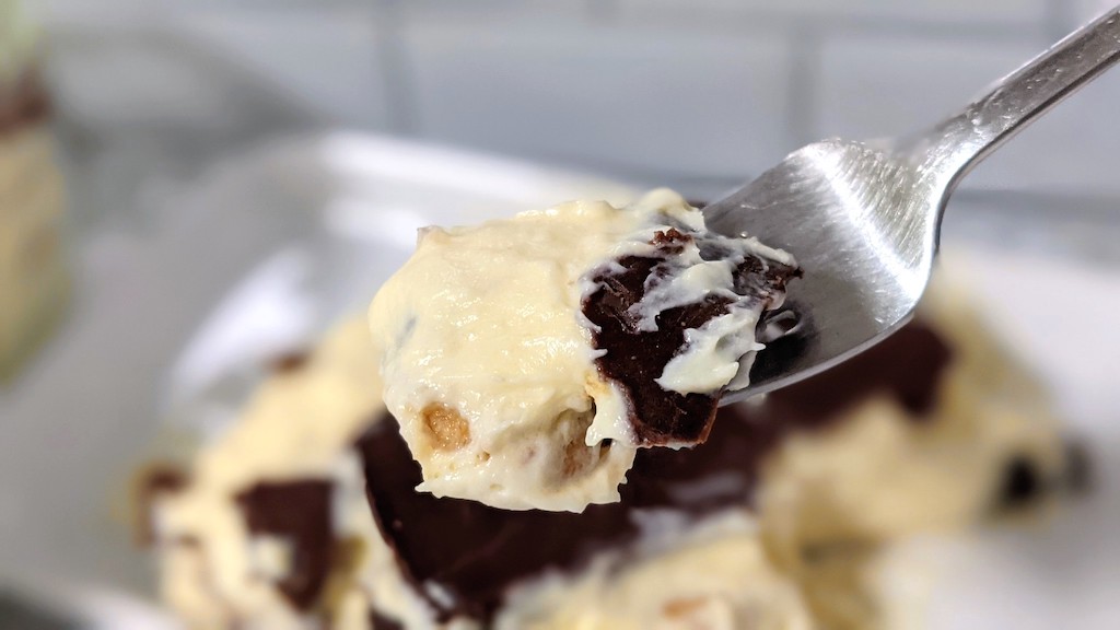 taking bite of keto eclair cake 